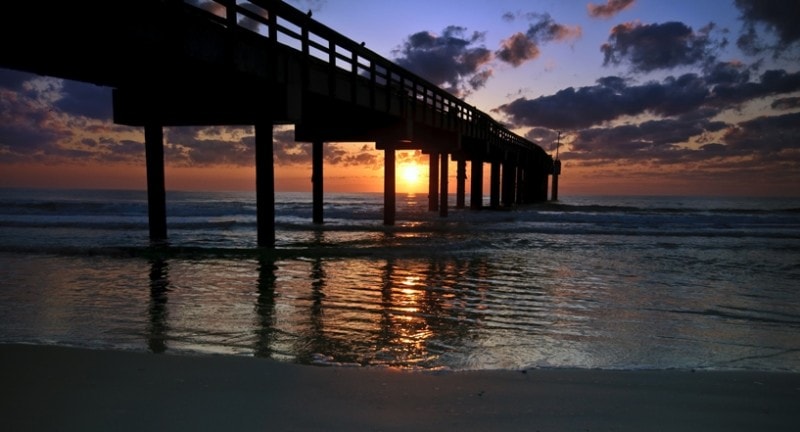 sunsets under the st augustine beach pier