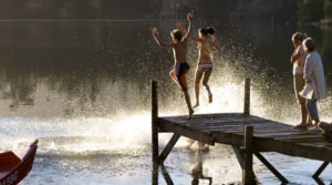 kids-jumping-in-river-on-multi-generational-holiday