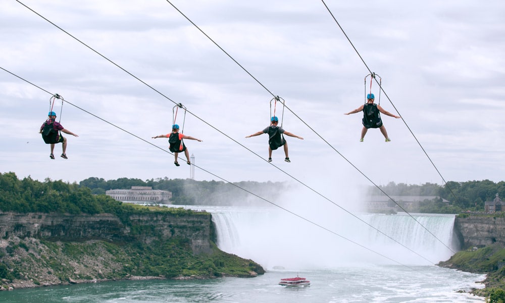 four-people-ziplining-together-on-mistrider-one-of-the-top-family-activities-at-Niagara-Falls