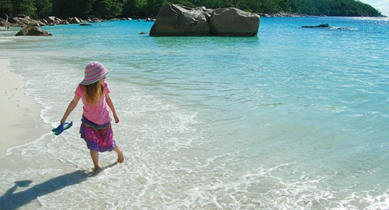 Child on the beach in The Seychelles