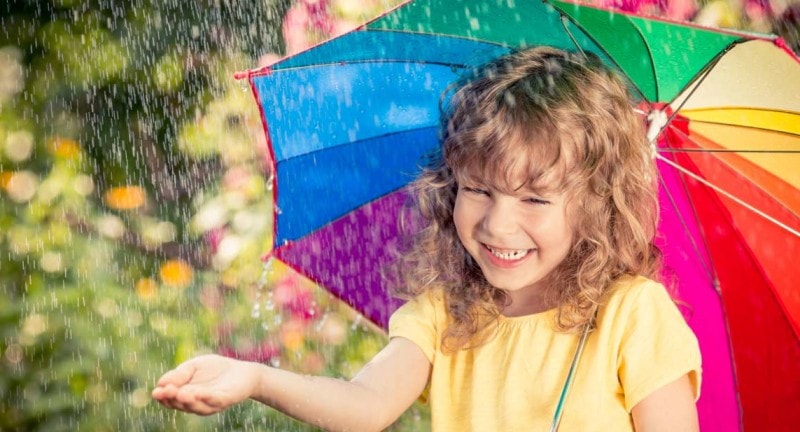 Child playing in the rain