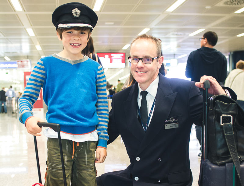 Pilot having his picture taken with young boy