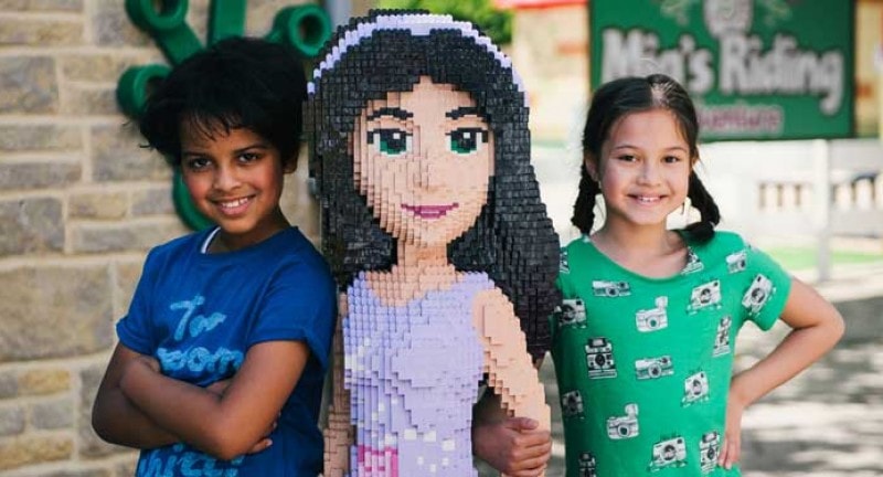 children stand by lego woman