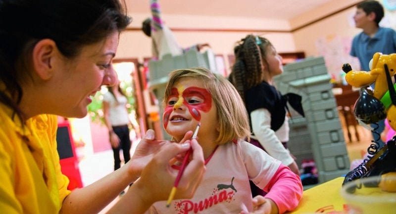 Girl having her face painted