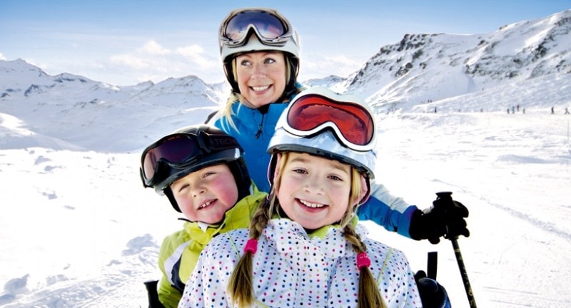 Family smiling on the slopes