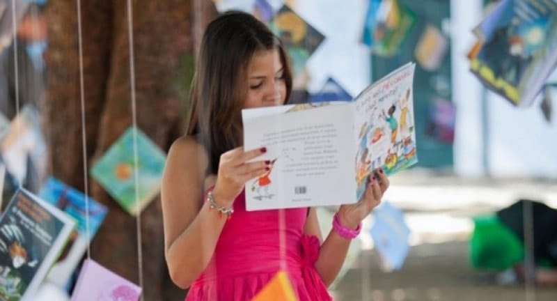 a girl reading books at flipside festival
