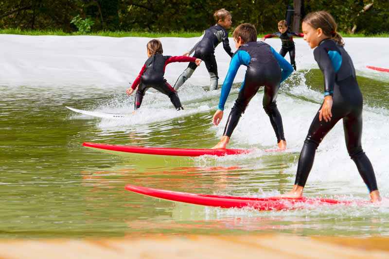group-of-young-children-surfing-in-wales