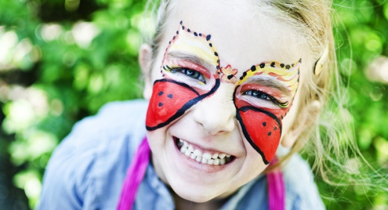 little girl with butterfly face paint at the geronimo festival