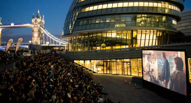 an audience watch a film on a screen at london riviera outdoors cinema screen