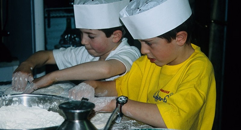 two children with hands in flour on a cruise ship
