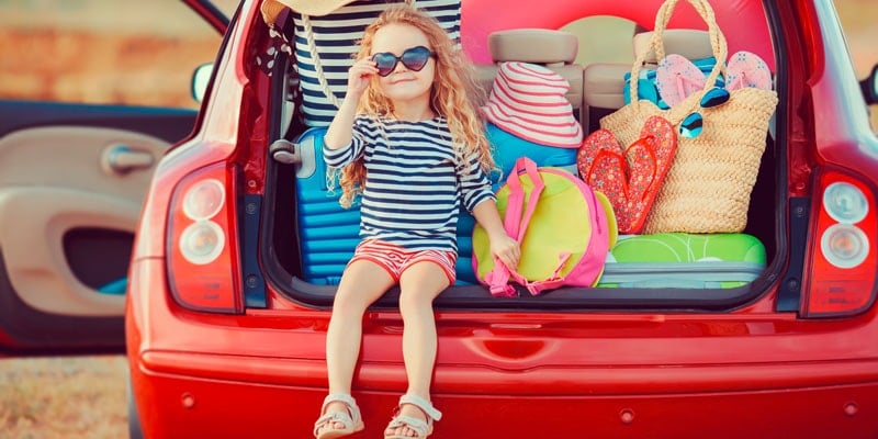 little-girl-in-boot-of-car-ready-to-go-on-holiday
