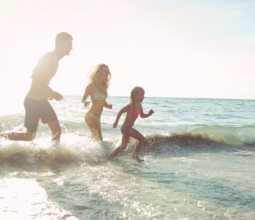 kids running on beach family holidays