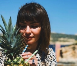 Woman enjoying a pineapple in Gozo