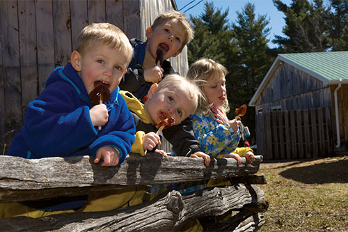 Children-enjoying-maple-taffy-at-Fulton's-Pancake-House-and-Sugar-Bush--Ottawa-Tourism