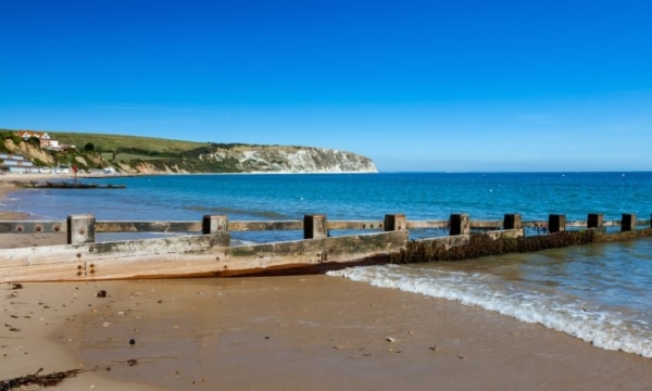 Blue sky and golden sandy beach at Swanage Dorset England UK Europe