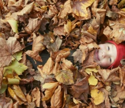 Kid buried in leaves