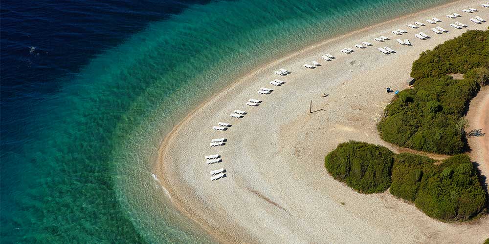 drone-shot-beach-sun-beds-alonissos-island-greece-2022