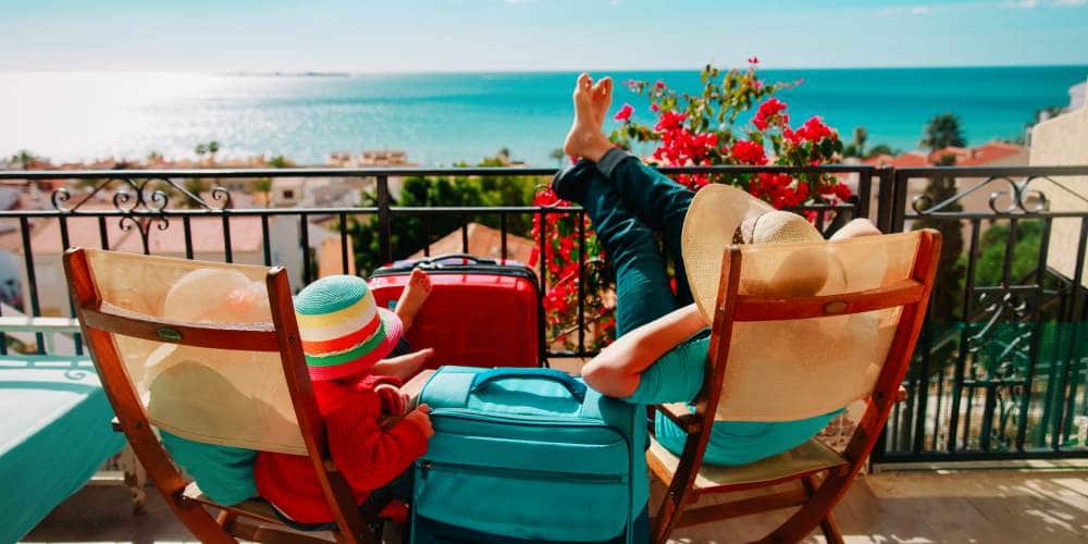 single-parent-holidays-easyjet-oneadult-discount-offer-mum-and-daughter-on-sunny-balcony-spain